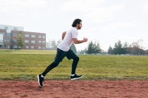 man in training running around the track