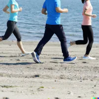 Three people jogging together on a sandy beach