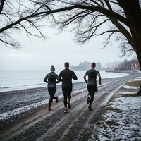 Two runners pacing a frosty beach path on a winter morning, a steady way to progress through a beginner running program