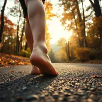 Runner seated on a forest trail pressing a thumb into the foot arch, the pain night splints and taping target